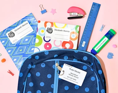 Personalised labels on a school bag, books, stationery and lunchbox