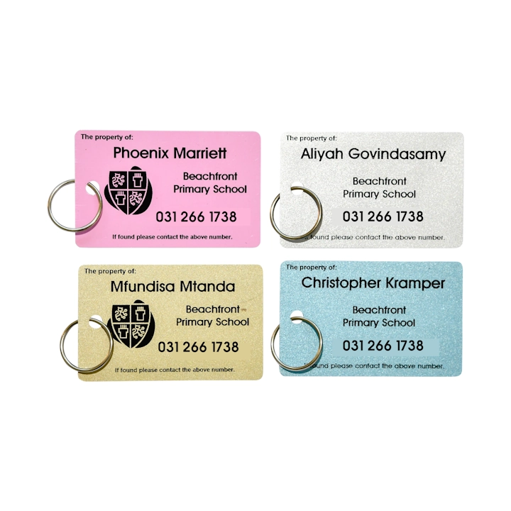 Personalised colour bag tag with black print attached to a backpack